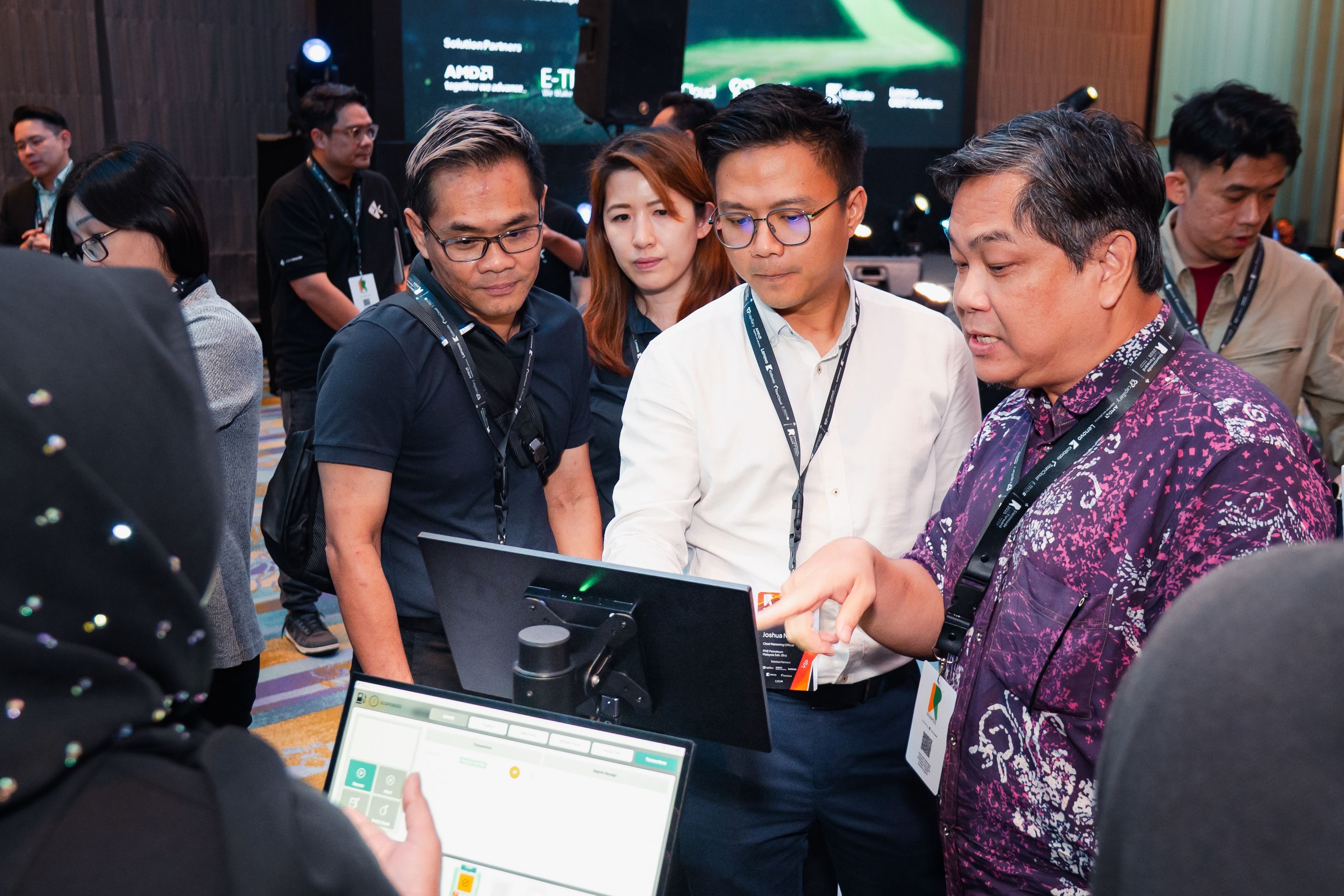 Visitors gathering around a RONPOS point of sale demo at an event