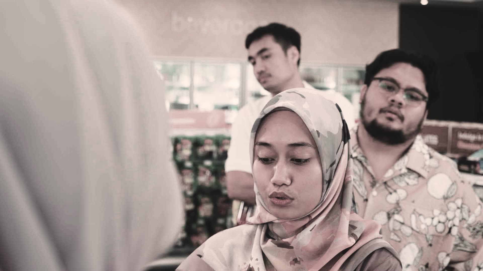 Cashier and customers at a convenience store using RONPOS